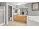 Bathroom with double sink vanity, tub, glass shower, and tile flooring at 9408 Ironsend St, Las Vegas, NV 89143