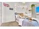 Bright and cozy bedroom with carpeted floors, soft decor, and personalized touches at 9408 Ironsend St, Las Vegas, NV 89143