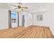 Bright bedroom with large windows, ceiling fan, and light-colored wood flooring at 9408 Ironsend St, Las Vegas, NV 89143