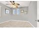 Bedroom with neutral carpet, ceiling fan, art and two windows providing natural light at 9408 Ironsend St, Las Vegas, NV 89143