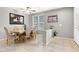 Formal dining room featuring tile flooring, a ceiling fan, and natural lighting at 9408 Ironsend St, Las Vegas, NV 89143