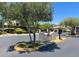 Community entrance with a monument sign, lush landscaping and gated entry at 9408 Ironsend St, Las Vegas, NV 89143