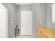 Neutral entryway featuring tile flooring, a storage cabinet, and a white door at 9408 Ironsend St, Las Vegas, NV 89143