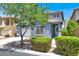 Inviting two-story home with mature landscaping and a charming front porch at 9408 Ironsend St, Las Vegas, NV 89143