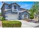 Beautiful two-story home boasting well-manicured landscaping and a spacious driveway at 9408 Ironsend St, Las Vegas, NV 89143