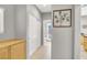 Neutral hallway featuring tile flooring, a storage cabinet, and access to a bathroom at 9408 Ironsend St, Las Vegas, NV 89143