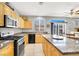 Bright kitchen with granite countertops, stainless steel appliances, and ample cabinet space at 9408 Ironsend St, Las Vegas, NV 89143