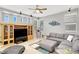 Open living room with large windows, neutral decor, and built-in shelves at 9408 Ironsend St, Las Vegas, NV 89143