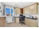 Well-lit office with built-in desk, cabinets and window offering a pleasant workspace at 9408 Ironsend St, Las Vegas, NV 89143