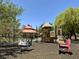 Community playground includes a gazebo, climbing structure and spring rider toys at 9408 Ironsend St, Las Vegas, NV 89143