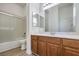 Bathroom featuring tiled shower over tub, toilet, and modern vanity at 9421 Wisdom Valley Ave, Las Vegas, NV 89149