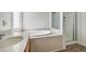 Bathroom featuring a soaking tub, a shower, and a large sink at 9421 Wisdom Valley Ave, Las Vegas, NV 89149