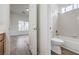 Bathroom featuring a toilet, tiled shower over tub, and modern fixtures at 9421 Wisdom Valley Ave, Las Vegas, NV 89149