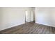Spacious bedroom with light gray wood-look flooring and neutral walls at 9421 Wisdom Valley Ave, Las Vegas, NV 89149
