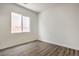 Bedroom featuring gray wood-look floors, a window, and neutral walls at 9421 Wisdom Valley Ave, Las Vegas, NV 89149