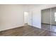 This is a bedroom with neutral walls, new floors, and an open closet at 9421 Wisdom Valley Ave, Las Vegas, NV 89149