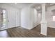 Bright entryway with wood-look flooring, white walls, and an arched doorway at 9421 Wisdom Valley Ave, Las Vegas, NV 89149