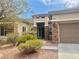Inviting single-story home featuring desert landscaping and a charming, covered entryway at 9421 Wisdom Valley Ave, Las Vegas, NV 89149