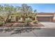 Single-story home featuring desert landscaping, a covered entryway, and attached two-car garage at 9421 Wisdom Valley Ave, Las Vegas, NV 89149
