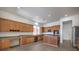 Modern kitchen featuring wood cabinets, stainless steel appliances, and a central island at 9421 Wisdom Valley Ave, Las Vegas, NV 89149