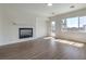 Bright living room featuring a modern fireplace, wood-look flooring, and recessed lighting at 9421 Wisdom Valley Ave, Las Vegas, NV 89149