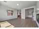 Open-concept living room with wood-look floors, recessed lighting, and adjacent kitchen at 9421 Wisdom Valley Ave, Las Vegas, NV 89149