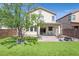 Backyard featuring a manicured lawn, decorative pavers, and a stucco exterior at 953 Via Del Tramonto St, Henderson, NV 89011