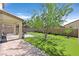 Inviting backyard featuring lush artificial turf, mature tree, and covered patio perfect for outdoor living at 953 Via Del Tramonto St, Henderson, NV 89011