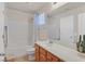 Bathroom featuring a combination tub and shower, white tiling, and a wood vanity at 953 Via Del Tramonto St, Henderson, NV 89011