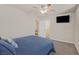 Bedroom featuring neutral paint, a ceiling fan, and a large bed with blue comforter at 953 Via Del Tramonto St, Henderson, NV 89011