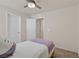 Bedroom with neutral walls, a ceiling fan, and a twin bed with a purple throw at 953 Via Del Tramonto St, Henderson, NV 89011