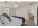 Bedroom featuring a ceiling fan and doorway to the laundry room with a white comforter and blue blanket at 953 Via Del Tramonto St, Henderson, NV 89011