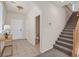 Welcoming entryway featuring a staircase and a convenient powder room, with neutral tile flooring at 953 Via Del Tramonto St, Henderson, NV 89011