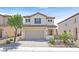 Two-story home with a two-car garage, low-maintenance landscaping, and a neutral color palette at 953 Via Del Tramonto St, Henderson, NV 89011