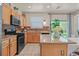 Modern kitchen with stainless steel appliances, granite countertops, and a tile backsplash at 953 Via Del Tramonto St, Henderson, NV 89011