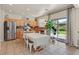 Bright kitchen with stainless appliances, a tile backsplash, and an island for seating or food prep at 953 Via Del Tramonto St, Henderson, NV 89011