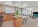 Bright kitchen featuring an island, granite countertops, tile backsplash, and a breakfast nook dining area at 953 Via Del Tramonto St, Henderson, NV 89011