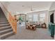 Open-concept living room featuring a staircase, plush carpeting, and abundant natural light at 953 Via Del Tramonto St, Henderson, NV 89011