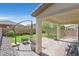 Covered patio with brick pavers, a built-in barbeque, and lush landscaping at 953 Via Del Tramonto St, Henderson, NV 89011