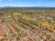 Breathtaking aerial view showcases a suburban neighborhood with a golf course and city skyline at 9540 Eagle Valley Dr, Las Vegas, NV 89134