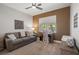 Well-lit home office with couch, desk near window, and modern décor at 9540 Eagle Valley Dr, Las Vegas, NV 89134