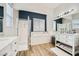 Well-lit bathroom featuring a walk-in shower, soaking tub, and dual vanities with modern finishes at , Las Vegas, NV 89149