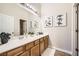 Bright bathroom featuring a double sink vanity with oak cabinetry and stylish decor at , Las Vegas, NV 89149