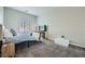 Minimalist bedroom with soft carpeting, TV, and a bed with blue bedding at , Las Vegas, NV 89149