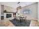 Elegant dining area with a modern chandelier, decorative stone fireplace, and neutral decor at , Las Vegas, NV 89149