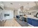 Spacious kitchen with stainless steel appliances, granite countertops, pendant lights, and blue cabinets at , Las Vegas, NV 89149