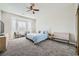 Spacious bedroom with plush carpeting, ceiling fan, and a comfortable seating area by the windows at , Las Vegas, NV 89149