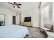 Cozy bedroom featuring soft carpet, a ceiling fan, and ample natural light from the window at , Las Vegas, NV 89149