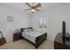 This bedroom has neutral colors, a ceiling fan, window with shutters, and a TV with dresser at 10181 Mount Harlow Ct, Las Vegas, NV 89141