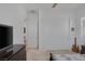 This bedroom has neutral colors, a ceiling fan, window with shutters, closet with sliding doors and TV with dresser at 10181 Mount Harlow Ct, Las Vegas, NV 89141